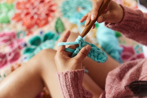 Lady showing how to knit.