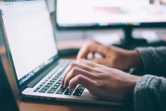 A Christian blogger typing away and ready to promote the blog.