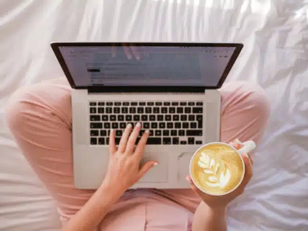 A top view of a laptop sitting on a blogger's lap. Most likely, blogging on a useful topic. 