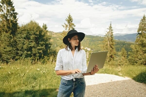 Female travel blogger blogging outdoors
